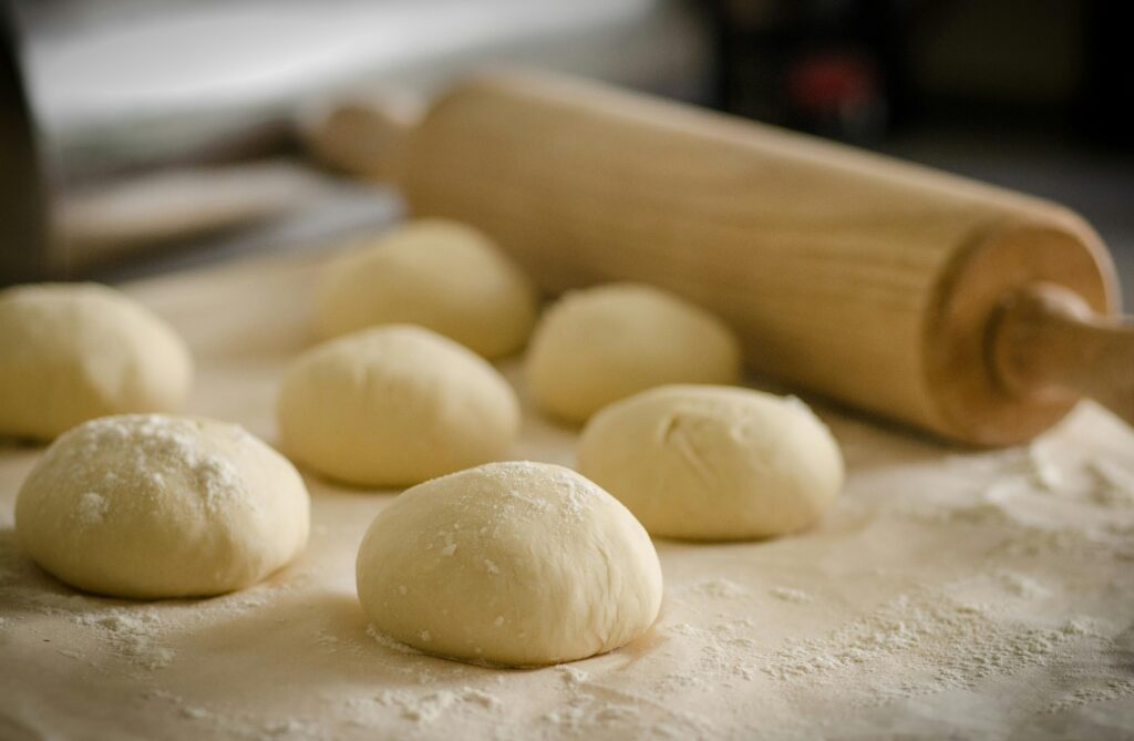 Close-up of freshly prepared dough balls ready for baking in a cozy kitchen.